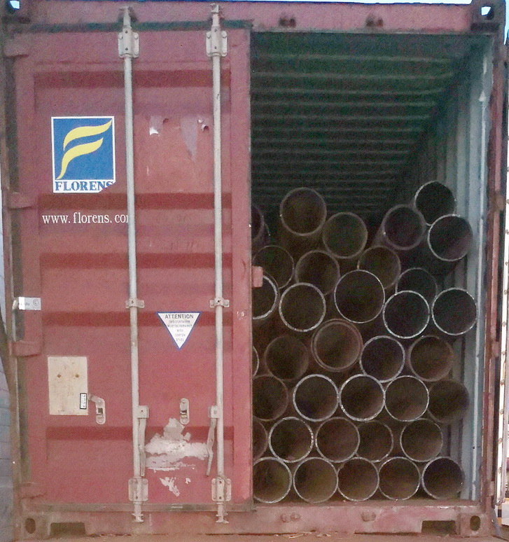 Close-up of rusted scrap metal pipes in a collection yard